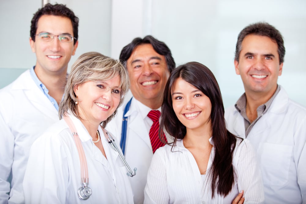 Female patient with a group of doctors at the hospital